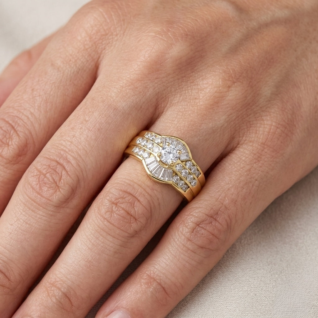 Gold ring with diamonds on a person's finger against a neutral background