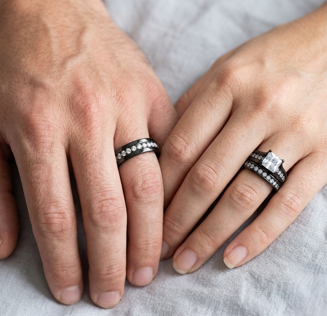 Close-up of two hands with wedding rings on a light fabric background