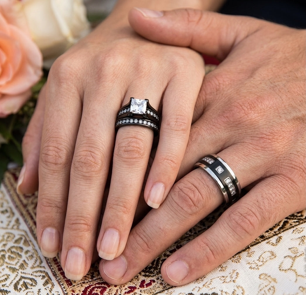 Close-up of two hands with rings on a decorative surface with flowers in the background