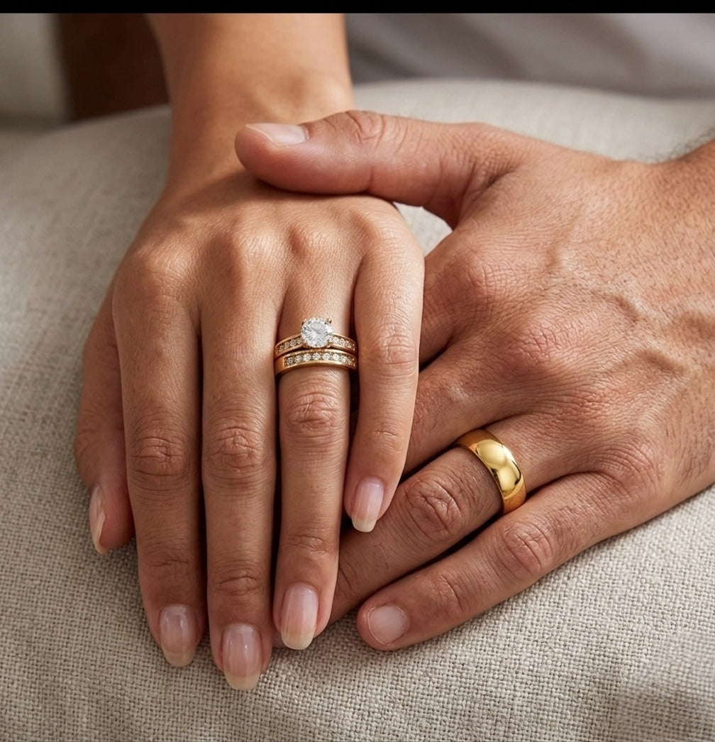 Two hands with rings on a textured surface